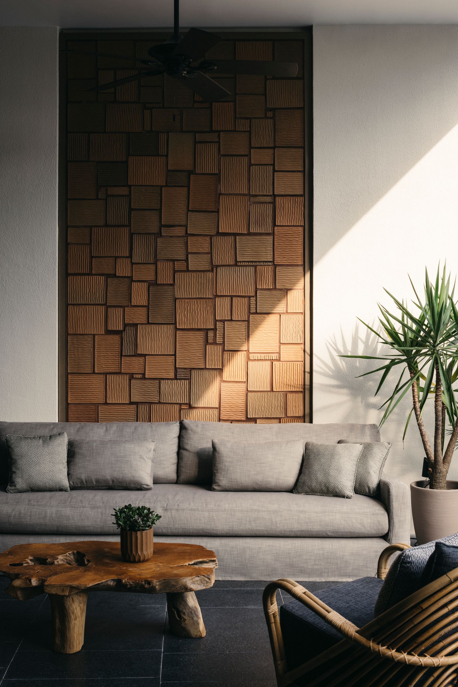 Image may contain Indoors Interior Design Wood Panels Plant Couch and Furniture