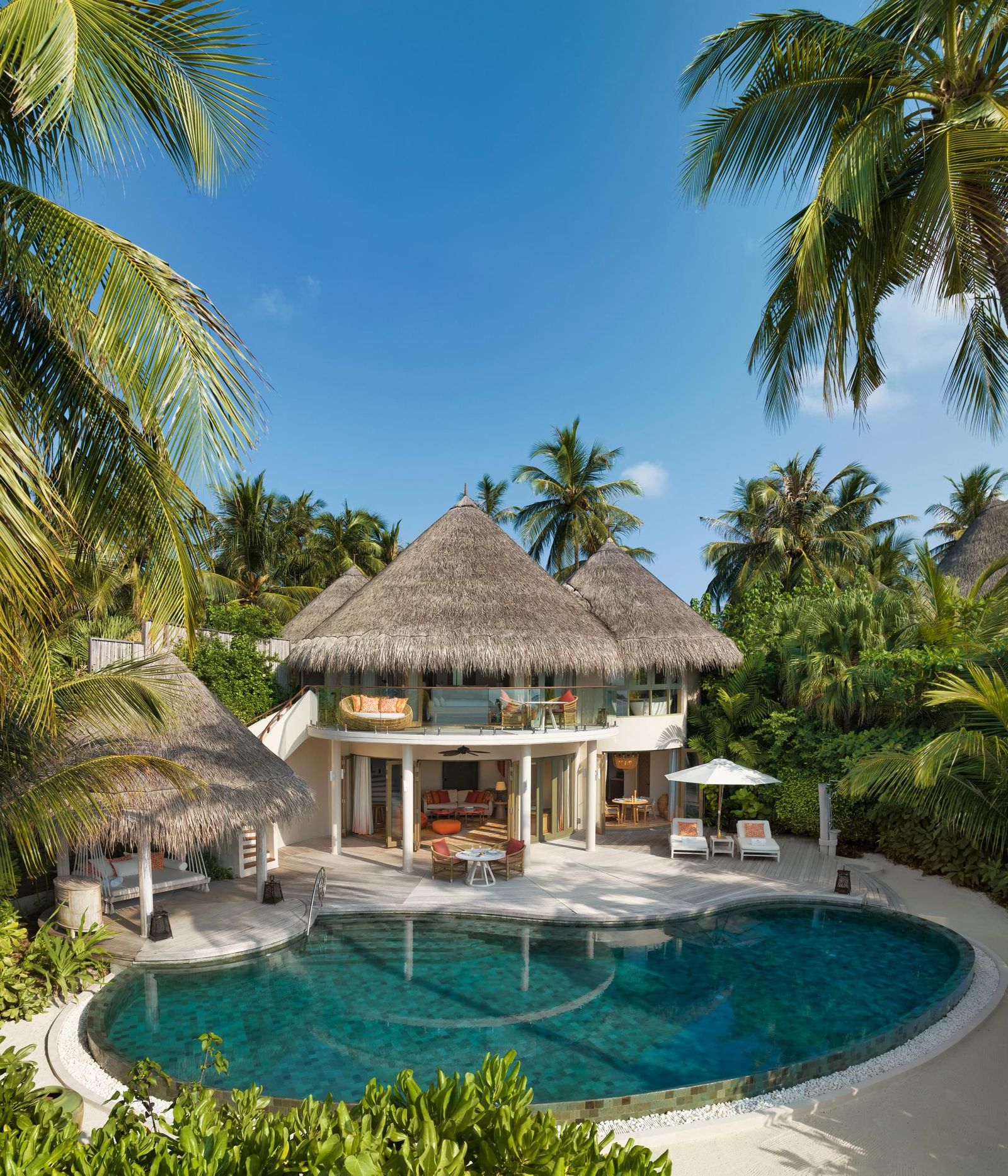 Image may contain Pool Water Architecture Building House Housing Villa Outdoors Swimming Pool Chair and Furniture
