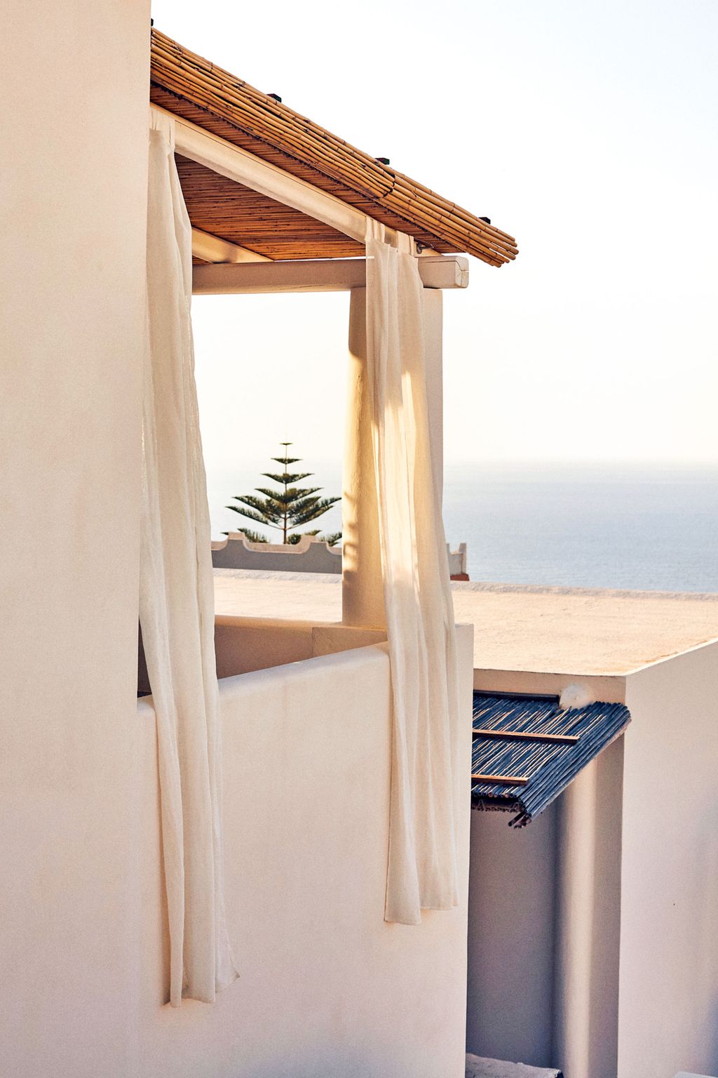 Pretty arches linen curtains catching the hot air and terraces gazing out wistfully towards the other smoking Aeolians....