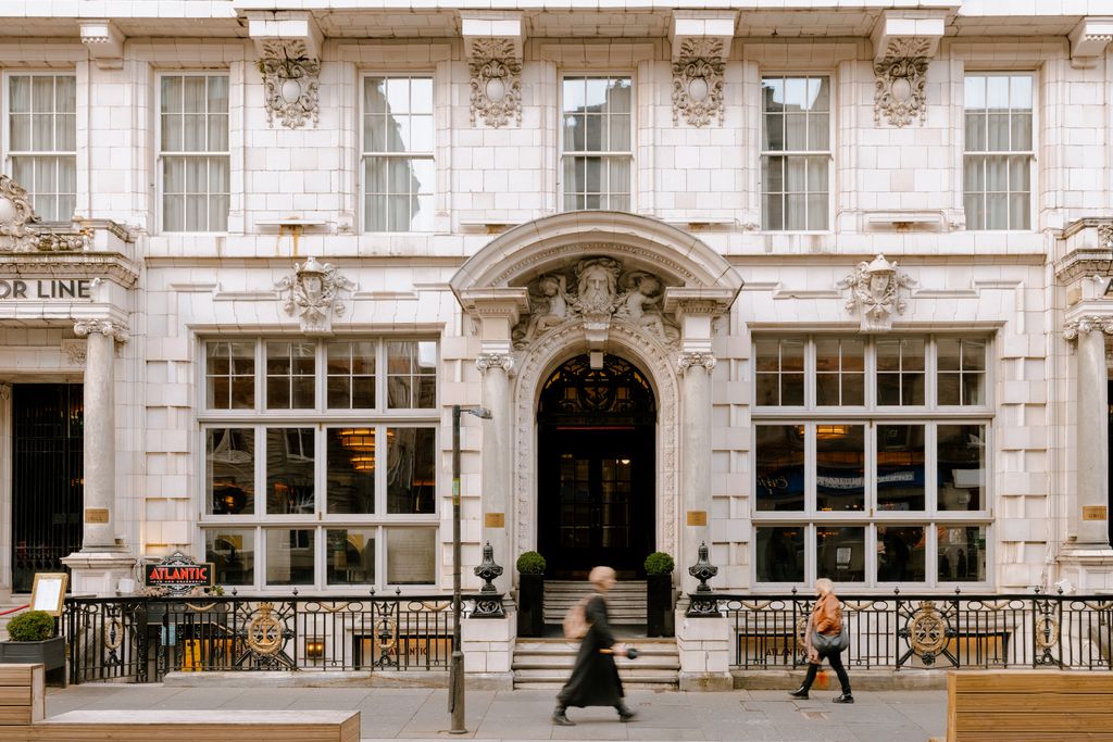 Image may contain City Plant Person Urban Accessories Bag Handbag Architecture Building Housing and Walking