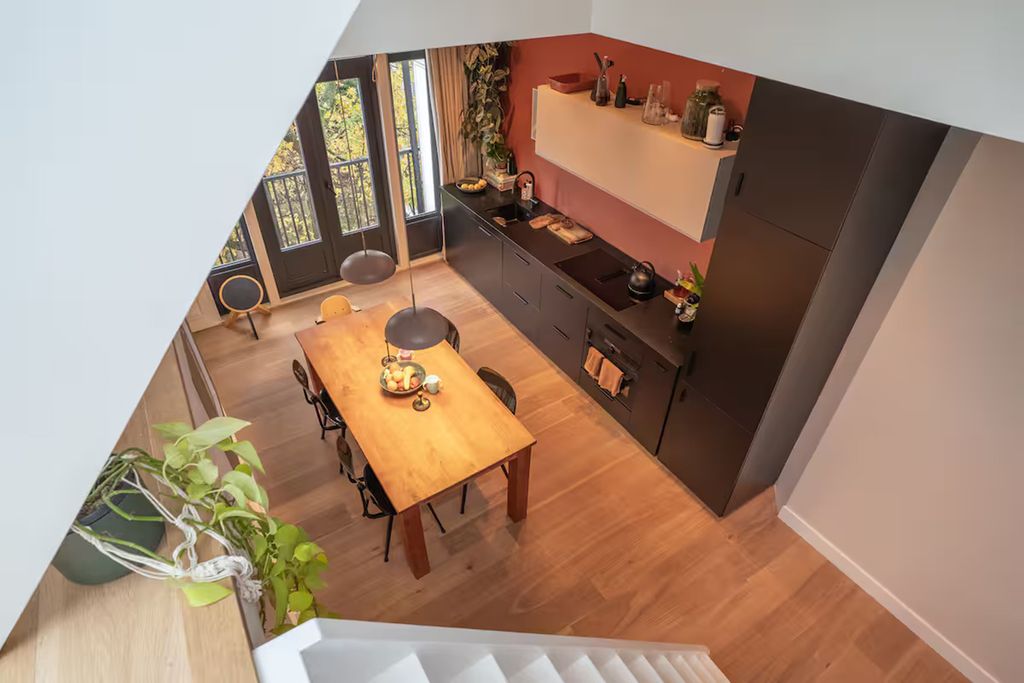 Image may contain Indoors Interior Design Floor Wood Furniture Table Architecture Building and Dining Room