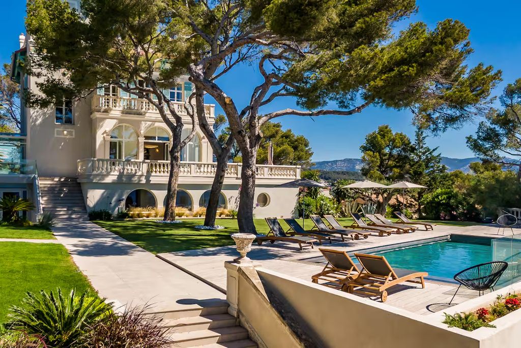 Image may contain Architecture Building House Housing Villa Pool Water Outdoors Swimming Pool Chair and Furniture